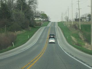 U.S. 20 east of LaGrange continues a relatively straight line along the rolling hills of the moraines of Northern Indiana. These hills are the deposits of the glaciers that ran across the region, leaving behind these moraines and small lakes around the landscape.