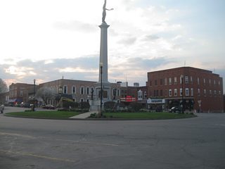 Another view of the traffic circle that forms the intersection of U.S. 20 (Maumee Street) and SR 127 (Wayne Street). Unlike other Indiana county seats where the courthouse is the center of the community, the Steuben County courthouse is located in the southeast corner of the square surrounding the circle.