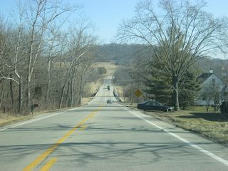 A view of SR 101 as it heads northeast out of the town of Brookville. The hill ahead is part of the dam holding Brookville Reservoir.