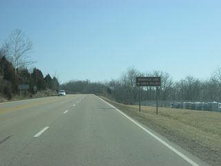SR 101 begins to climb from the valley of the Whitewater River Valley as it passes by the Brookville Lake Dam and Spillway.