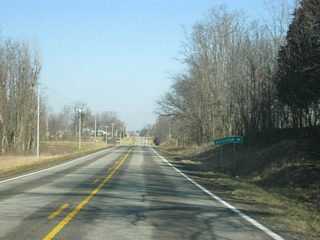 SR 101 passes by the intersection with Contreras Pike, heading east to the town of Billingsville.