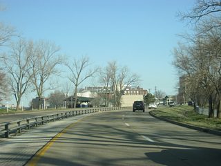 The Downtown Evansville skyline comes into view as the Veterans Memorial Parkway passes by Sunset Avenue toward the intersection with Riverside Drive.