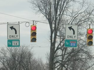 Signs guide traffic at the northbound intersection of Getz Road with Illinois Road onto SR 14 west and Interstate 69. The shields are obviously not INDOT created.
