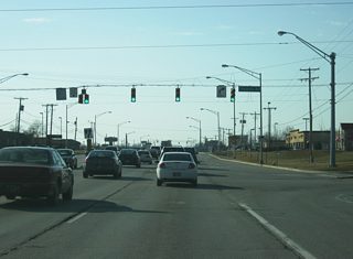 Illinois Road at the intersection with Thomas Road and Apple Glen Boulevard. Thomas Road heads north from Illinois Road to Bass Road while Apple Glen Boulevard arcs around the western boundary to the Jefferson Pointe shopping center back to Jefferson Boulevard.