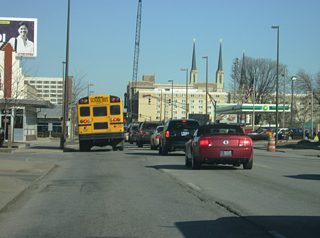 East of Broadway Street, Jefferson Boulevard nears Downtown Fort Wayne as the road is generally three lanes in width heading east. The twin spires of the Cathedral of the Immaculate Conception looms in the distance. The stoplight up ahead is with Fairfield Avenue.