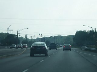 Southwest of Covington Road, Jefferson Boulevard begins to transition into a suburban highway as it gains a grassy median and passes by more shopping centers en route toward the interchange with Interstate 69/U.S. 33.