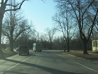 West of Broadway Street, Washington Boulevard becomes a residential two-way street even as it remains heavy with traffic. Since Interstate 69 was routed to the west of Fort Wayne, streets such as Washington and Jefferson Boulevards still carry heavy commuter traffic out of Downtown each weekday. In the second picture, Washington Boulevard crosses the intersection with College Street.