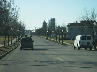 West of Anthony Boulevard, Washington Boulevard follows the old routing of U.S. 24, U.S. 30 and SR 14 west toward Downtown Fort Wayne. The road typically consists of three westbound lanes at it passes by the campus of Indiana Tech in the first picture, the intersection with Harmar Street in the second picture and Hanna Street in the fourth picture.
