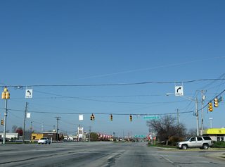 Six lanes of Crawfordsville Road intersect Cunningham Road amid retail on all directions.