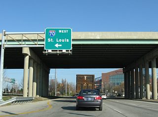 The westbound on-ramp forms a brief frontage street connecting Missouri (north) and West (south) Streets within Exit 79A. Interstate 70 spans the White River to West Indianapolis and continues to Indianapolis International Airport (IND), Terre Haute and St. Louis.