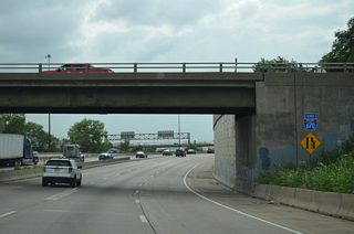 An end sign stands beside the Mill Street overpass as Interstate 670 merges with I-70 at a wye interchange.