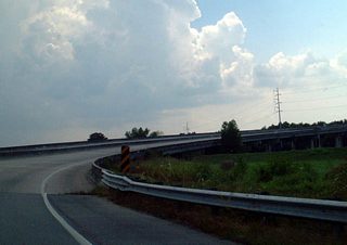 LA 407 loops onto the high rise Intracoastal Waterway Bridge from LA 406 (Woodland Highway) at New Aurora in southeast New Orleans.