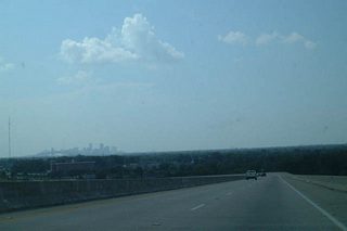 The Downtown skyline and Crescent City Connection Bridge appear along the northern horizon as LA 407 descends toward the Algiers section of the city. Algiers is located along the Mississippi River near the Greater New Orleans Bridge. During the late 19th Century, a devastating fire ravaged this portion of the city.