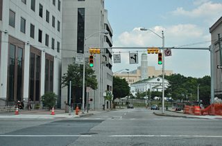 Lexington Street passes by War Memorial Plaza and then intersects Gay Street. Gay Street leads one block north to Saratoga Street and a northbound on-ramp to Interstate 83 (Jones Falls Expressway). Lexington Street otherwise ends one block east at Frederick Street.
