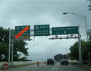 Westbound West 28th Street at Interstate 83 (Jones Falls Expressway) and Druid Hill Park.