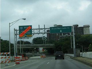 Westbound West 28th Street at Interstate 83 (Jones Falls Expressway) and Druid Hill Park.