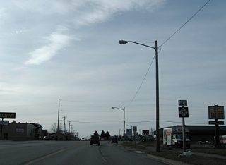 Ashmun Street (M-129) splits with Business Spur I-75 as the arterial turns southwest to Interstate 75 (Exit 392).