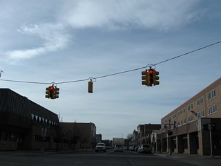 Traffic lights hang above Business Spur I-75 (Ashmun Street) south at Spruce Street. Spruce Street spans the Edison Power Canal to Easterday Avenue and Mission Road.
