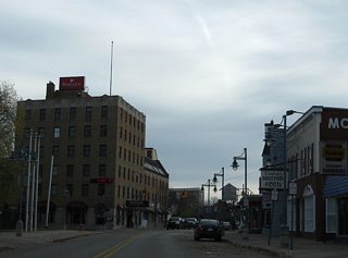 A set of traffic lights hang above the intersection of West Portage Avenue and Osborn Boulevard. Osborn Boulevard connects Spruce Street with Park Place.