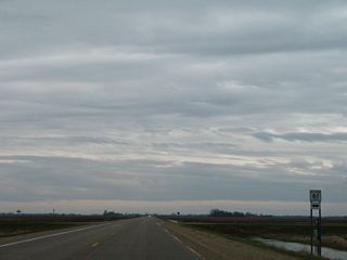 CR 61 traverses agricultural and wetland areas north and south of MN 28.