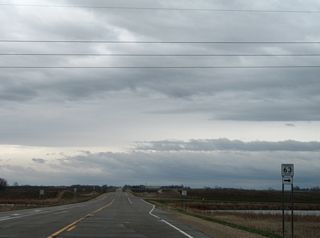 Stevens County Highway 63 heads south through agricultural areas west of the Poome De Terre River.