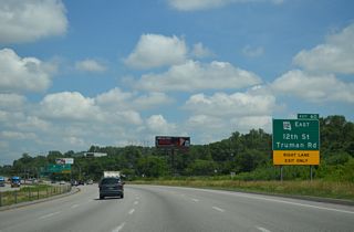 An S-curve takes I-435 northbound to the modified diamond interchange (Exit 60) with Route 12 (Truman Road) and 12th Street.