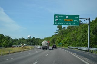 An interchange sequence sign lists the three Missouri side interchanges of Interstate 635 south. A cloverstack interchange (Exits 11B/A) joins the freeway with Route 9 and U.S. 69 north next.