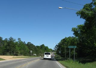 Curving southeast from Iowa Street, MS 26 (Central Avenue) intersects Stapp Street by this distance sign 33 miles from Lucedale.