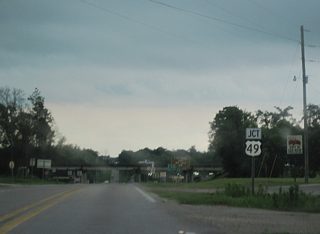 Entering the Stone County seat of Wiggins, MS 26 converges with U.S. 49 (Azalea Drive) at a diamond interchange.