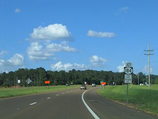 Prior to completion of the four-lane bypass of Brookhaven, U.S. 84 followed Natchez Drive northeast to an overlap with U.S. 51. Designated MS 184, the old alignment continues east from U.S. 51 along Brookway Boulevard (MS 558) and Monticello Street to Downtown Brookhaven.