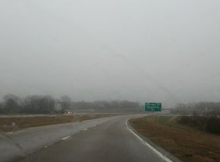A folded diamond interchange joins U.S. 84 with Old Highway 27 east of the CN Railroad underpass.
