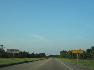 U.S. 90 narrows from a four lane, divided highway to two lanes at the Alabama state line.