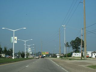 Continuing into the city of Waveland east from Lower Bay Road, U.S. 90 curves northward from the intersection with Bloom Place.
