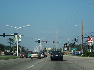 Kiln Waveland Cutoff Road ties into U.S. 90 at a signalized intersection across from Waveland Avenue, 1.46 miles south from MS 43/603.
