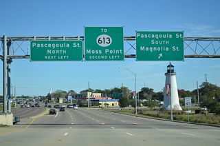 MS 613 angles southwest along Telephone Road to end along U.S. 90 (Denny Avenue) westbound between Pascagoula Street and Market Street. Market Street connects U.S. 90 eastbound with the state highway north to Moss Point.