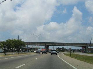 A viaduct takes 14th Street across both U.S. 90 (Denny Avenue) and the nearby CSX Railroad line. Traffic lights were added with the frontage road system adjacent to the overpass by 2008.