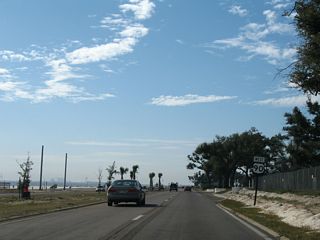 The U.S. 90 shield preceding Centennial Plaza was removed during 2008 reconstruction of Beach Boulevard. Traffic lights were added at Centennial Plaza by 2022.