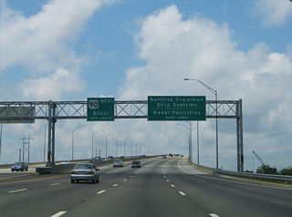 Replacing a four lane draw bridge, the high rise Jackson County Veterans Memorial Bridge was built in 2002. The eight lane span stretches west from Pascagoula Street to unsigned MS 619 south to the Ingalls Shipbuilding facility and Port of Pascagoula.
