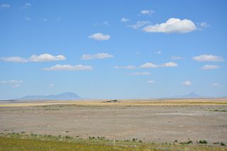 The East Butte and West Butte of the Sweet Grass Hills appear far to the east.