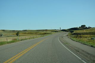 Continuing through north Shelby, Business Loop I-15/MT 67 (Oilfield Avenue) pass west of Lake Shel-oole.