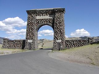 Built in the spring of 1903, the Roosevelt Arch was constructed to provide a dramatic northern entrance into Yellowstone National Park in Gardiner, Montana. This arch still stands today, with the motto "For the Benefit and Enjoyment of the People" inscribed in it. U.S. 89 no longer passes under the arch, since the archway is too narrow to accommodate two-way traffic. This is the view looking south, toward the entrance into Yellowstone.