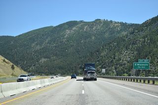I-90/U.S. 12-MT 200 travel east through Hellgate Canyon between Mount Jumbo to the north and University Mountain to the south. Broadway Street follows the Clark Fork river east before crossing the BNSF Railroad north into the diamond interchange at Exit 107.