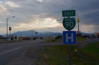 The lone reassurance marker for Business Loop I-90 eastbound stands along Main Street at Village Lane, just west of I-90.