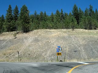 Business Loop I-90 and Montana Secondary Highway 507 overlap 2.33 miles west from I-90 at Exit 77 to Exit 75. This shield assembly was formerly posted where Petty Creek Road turns west at Exit 77.