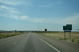 A trumpet interchange joins I-94/U.S. 12 with the west end of the Miles City business loop at Exit 135.