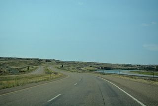 Interstate 94 overtakes the old alignment of U.S. 10 along the BNSF Railroad and Yellowstone River south from mile marker 156 and Hay Creek.
