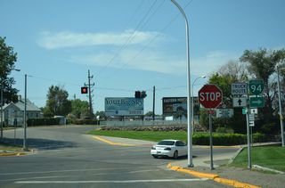 Business Loop I-94 combines with MT 59 along Main Street west at a three-way stop sign. MT 59 is not marked along Valley Drive leading into the intersection.