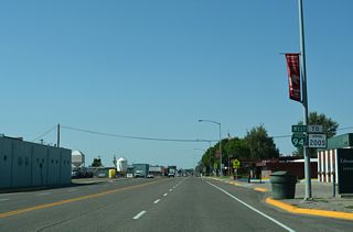 The Business Loop I-94 shield assembly preceding Slocum Street was relocated further west by 2018 and subsequently replaced with a hanging planter by 2024.