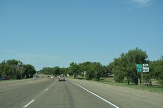 Business Loop I-94 runs west along History Park ahead of MT 200S.