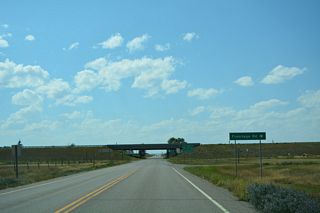 The east Frontage Road for Interstate 15 runs north from S-343 (Oilmont Highway) to S-552 (Nine Mile Road) near Sunburst.